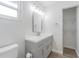 Bathroom featuring new vanity, gray cabinets, new lighting and updated mirror at 3505 Medulla Rd, Plant City, FL 33566