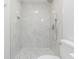 Modern bathroom featuring a sleek shower with a rainfall shower head, and elegant mosaic tile flooring at 3505 Medulla Rd, Plant City, FL 33566