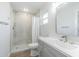 This stylish bathroom offers a modern vanity with a sleek sink and faucet and a tiled walk-in shower at 3505 Medulla Rd, Plant City, FL 33566