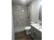 Bathroom featuring a new tile shower with a rainfall showerhead and wood-look flooring at 3505 Medulla Rd, Plant City, FL 33566