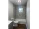 Modern bathroom featuring new tile tub surround, and wood-look flooring at 3505 Medulla Rd, Plant City, FL 33566