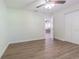 Bedroom with wood floors, closet, and an open door looking out to a dining room at 3505 Medulla Rd, Plant City, FL 33566