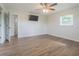 Comfortable bedroom featuring sleek wood floors, a modern ceiling fan, and natural light for relaxation at 3505 Medulla Rd, Plant City, FL 33566