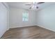 This cozy bedroom features hardwood floors, a ceiling fan, a closet, and natural light through a window at 3505 Medulla Rd, Plant City, FL 33566
