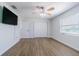 This bedroom features hardwood floors, a ceiling fan, natural light, and a closet with double doors at 3505 Medulla Rd, Plant City, FL 33566