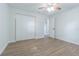 Bright bedroom featuring wood-look flooring, a ceiling fan, and a spacious closet at 3505 Medulla Rd, Plant City, FL 33566
