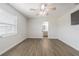 Bedroom featuring wood floors, a ceiling fan and view into bathroom with updated vanity at 3505 Medulla Rd, Plant City, FL 33566