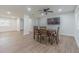 Open dining room featuring seating for four and a flat screen television, perfect for gatherings and entertaining at 3505 Medulla Rd, Plant City, FL 33566