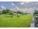 Exterior shot of home's yard, with solar panels, sheds, and lush greenery at 3505 Medulla Rd, Plant City, FL 33566