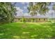 This lovely home features a brick facade, metal roof, and mature landscaping at 3505 Medulla Rd, Plant City, FL 33566