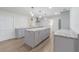 Open kitchen with granite countertops, grey cabinets, modern appliances, and center island with pendant lighting at 3505 Medulla Rd, Plant City, FL 33566