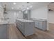 Modern kitchen featuring grey cabinets, stainless steel appliances, and a large island with elegant marble countertop at 3505 Medulla Rd, Plant City, FL 33566