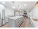 Open concept kitchen with stainless steel appliances, marble counters and an island, perfect for entertaining at 3505 Medulla Rd, Plant City, FL 33566