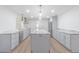 Bright kitchen features grey cabinets, stainless steel appliances, marble countertops, and a large center island at 3505 Medulla Rd, Plant City, FL 33566