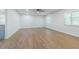 Spacious living room featuring sleek wood floors and a modern ceiling fan for a comfortable and stylish home at 3505 Medulla Rd, Plant City, FL 33566
