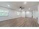 Bright and airy living room featuring lots of natural light and modern wood floors for comfortable living at 3505 Medulla Rd, Plant City, FL 33566