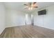 This bright main bedroom has a ceiling fan, TV, and ensuite bath at 3505 Medulla Rd, Plant City, FL 33566