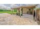Paved patio connects to a covered shed area in a spacious yard with well maintained landscaping at 3505 Medulla Rd, Plant City, FL 33566