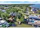 Aerial view of the waterfront property featuring a private dock, easy water access, and beautiful residential landscaping at 4173 85Th N St, St Petersburg, FL 33709
