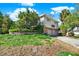 Two story home featuring a two car garage, brick accents, and lush landscaping at 4173 85Th N St, St Petersburg, FL 33709