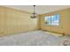 Living room featuring yellow walls, chandelier, and a bright window at 4173 85Th N St, St Petersburg, FL 33709