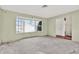 Bright living room with a large bay window and an open doorway, lots of natural light at 4173 85Th N St, St Petersburg, FL 33709