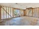 A partially renovated room with exposed framing, large windows and natural light at 4173 85Th N St, St Petersburg, FL 33709