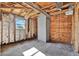 Renovation project showcases exposed framing, insulation, and a gray painted brick chimney at 4173 85Th N St, St Petersburg, FL 33709