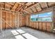 Unfinished room with wood framing, exposed beams, and a large window at 4173 85Th N St, St Petersburg, FL 33709