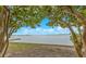 Peaceful waterfront view framed by tree branches showcasing calm water and a distant shoreline at 4173 85Th N St, St Petersburg, FL 33709