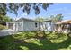 This home has a big backyard featuring lush green grass, storage shed and shade trees at 4637 4Th N Ave, St Petersburg, FL 33713