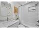Bright bathroom with a subway tiled shower/tub, modern vanity with marble countertop, and updated fixtures at 4637 4Th N Ave, St Petersburg, FL 33713