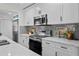 Modern kitchen featuring stainless steel appliances, white cabinets, and quartz countertops at 4637 4Th N Ave, St Petersburg, FL 33713
