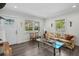 Bright living room with hardwood floors, large windows, and a comfortable seating area at 4637 4Th N Ave, St Petersburg, FL 33713
