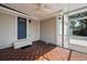 Inviting covered patio with a ceiling fan, deck-style wood flooring, and convenient access to the backyard at 4637 4Th N Ave, St Petersburg, FL 33713