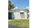 Exterior side view featuring white siding, a storage shed, and neat landscaping, enhancing the property's appeal at 4851 W Gandy Blvd # B7L36, Tampa, FL 33611