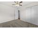 Neutral carpeted bedroom featuring a ceiling fan, closet and white walls creating a bright atmosphere at 4945 91St N Ave # 30, Pinellas Park, FL 33782