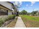 Exterior view of home featuring green space and plants at 4945 91St N Ave # 30, Pinellas Park, FL 33782