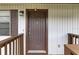 A close up of a home's brown front door with white siding at 4945 91St N Ave # 30, Pinellas Park, FL 33782