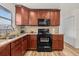 Functional kitchen featuring wood cabinets, stainless steel appliances and a tiled backsplash at 4945 91St N Ave # 30, Pinellas Park, FL 33782