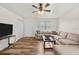 Bright living room featuring hardwood floors, neutral walls, and a comfortable sectional sofa at 4945 91St N Ave # 30, Pinellas Park, FL 33782