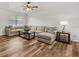 Spacious living room with hardwood floors and a large sectional sofa at 4945 91St N Ave # 30, Pinellas Park, FL 33782