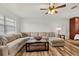 Inviting living room featuring wood-look floors and a plush sectional sofa at 4945 91St N Ave # 30, Pinellas Park, FL 33782