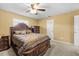 Comfortable primary bedroom featuring a ceiling fan, large bed, and dresser at 4945 91St N Ave # 30, Pinellas Park, FL 33782