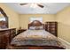 Comfortable primary bedroom featuring a ceiling fan, large bed, and dresser at 4945 91St N Ave # 30, Pinellas Park, FL 33782