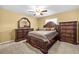Comfortable primary bedroom featuring a ceiling fan, large bed, and dresser at 4945 91St N Ave # 30, Pinellas Park, FL 33782