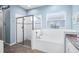 Bright bathroom features a glass shower, large tub, and granite countertop vanity at 511 Winterside Dr, Apollo Beach, FL 33572