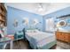 Coastal-themed bedroom boasts blue walls, ceiling fan, and nautical decorations for a relaxing atmosphere at 511 Winterside Dr, Apollo Beach, FL 33572