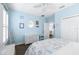 Light blue coastal-themed bedroom includes wood-look flooring, closet, and woven decor at 511 Winterside Dr, Apollo Beach, FL 33572