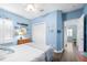 A nautical-themed bedroom features beachy decor, ceiling fan, closet, and light blue walls at 511 Winterside Dr, Apollo Beach, FL 33572